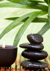 Balanced pebbles and aromatherapy candle