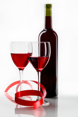 bottle with red wine and glass a decorative tape