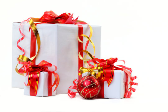 A white box tied with a red satin ribbon bow. A gift for Christm