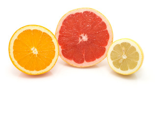half of orange, lemon and grapefruit on white background