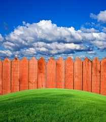 wooden fence on a green hill