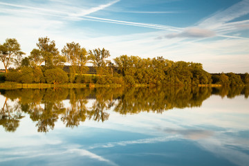 Reflection on the pond at sunset in autumn