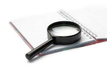 Magnifying glass and pad isolated on white