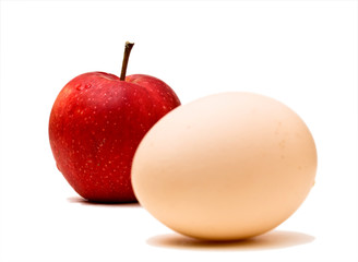 Red apple with egg  isolated on white