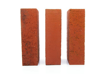 three red clay bricks, on white