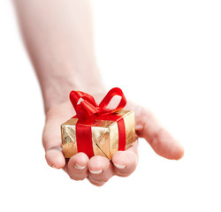 Hand of a girl with a gift isolated on white