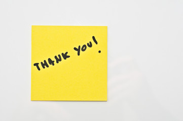 Yellow square Post it with Thak you  written on it