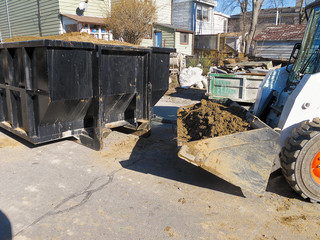 Front end loader and disposal dumpster