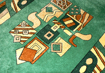 Abstract pattern on a green carpet