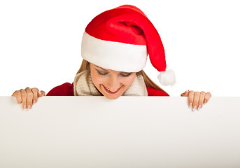 Woman in santa hat with christmas presents