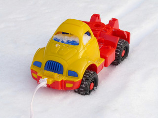 Children's plastic machine on snow