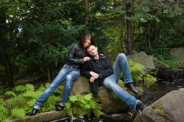 Young couple in park on a shore