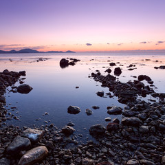 colorful sunrise on the rocky sea coast