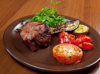 Grilled beef on white plate  with vegetable.