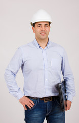 Picture of an Engineer with white hat and a laptop computer