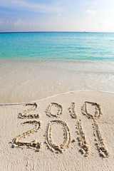 New 2011. The wave washes off an inscription 2010