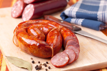 sausage on a wooden cutting board.