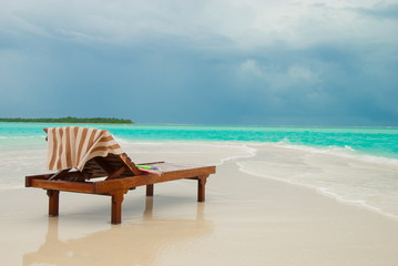Fototapeta na wymiar Sun lounger on tropical beach