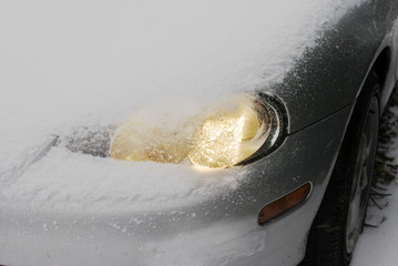 Car headlamp in snow © nickos