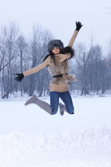 Woman jumping in snowy outdoor