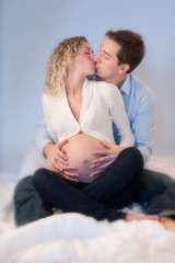 Young expectant couple kissing