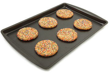 Sugar Cookies With Colorful Sprinkles On Baking Sheet