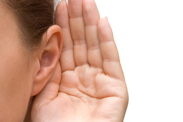 Girl listening with her hand on an ear - obrazy, fototapety, plakaty