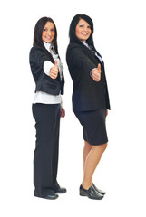 Business women giving thumbs