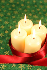 Candles and ribbon on Christmas background