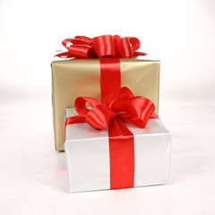 Gifts in silver and gold wrapping with red bow