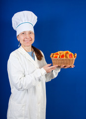 senior  cook   in toque with pastry