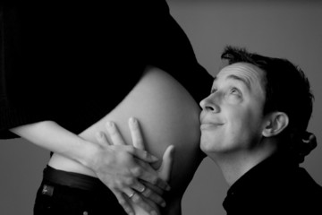 Father holding mother's belly