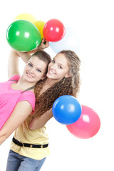 Fototapeta na wymiar two young girls with balloons over white