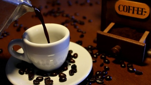 Cup of coffee and coffee grinder
