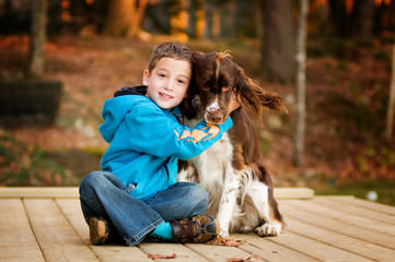 little boy with his pet springer spaniel dog
