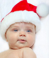 Baby girl wearing a Santa Claus hat