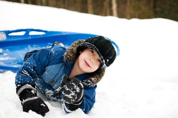 boy playing outdoors in the winter snow