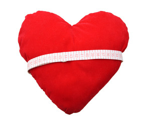 red heart with measuring tape isolated on white