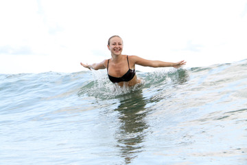 beautiful woman bathes at ocean