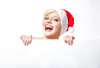 Cheerful santa woman holding empty white board