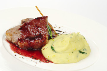Mashed potato with meat, red sauce, fresh rosemary