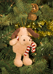 Fluffy dog ornament on Christmas tree