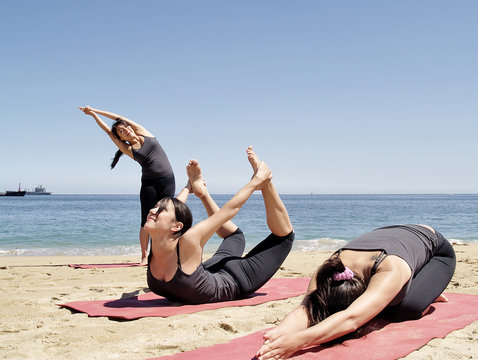 Composition of several bikram yoga poses at beach