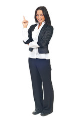 Young business woman pointing up