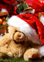 A cute little teddy bear in a Christmas hat