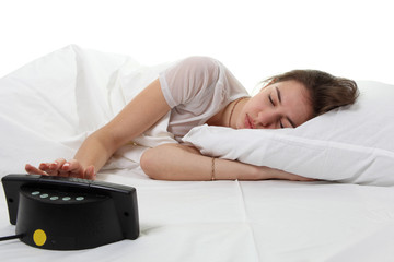 Woman in a bed with alarm clock