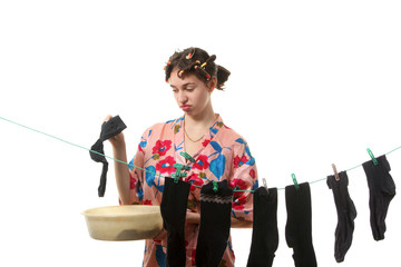 Housewife hangs up socks on  the clothesline