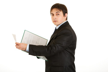Serious modern businessman  holding folder with documents