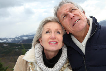 Portrait of happy senior couple at the mountain