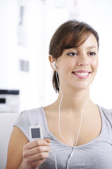 Naklejka premium young woman listening music in home interior.